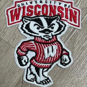 May include: Embroidered patch featuring the University of Wisconsin mascot, a badger wearing a red and white striped sweater with a white 'W' on the front. The patch is white with red lettering that reads 'University of Wisconsin'.