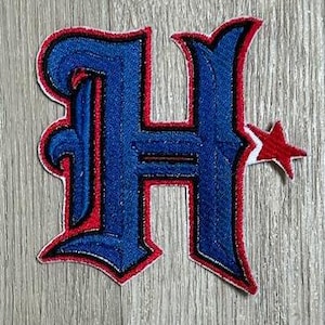May include: Blue and red embroidered iron-on patch with a stylized letter H and a red star.