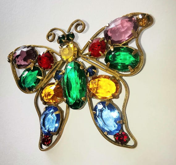 1930s Butterfly Brooch with multi-coloured faceted Czech Glass stones, large green lozenge to centre. Unsigned. Neiger Brothers.