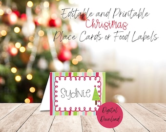 May include: A Christmas place card or food label with the name "Sydnie" in a decorative frame. The card has a green Christmas tree graphic and is set against a blurred Christmas tree background. Text on the card reads "Editable and Printable Christmas Place Cards or Food Labels".