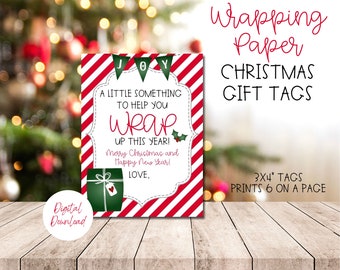 May include: A Christmas gift tag with a red and white striped border and a white center with text. The text reads "A little something to help you wrap up this year!" and "Merry Christmas and Happy New Year!"