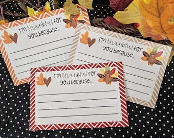 May include: Thanksgiving cards with the text "I'm thankful for you because..." feature a turkey illustration and autumn leaf accents. The cards have lined spaces for writing and decorative borders in orange, brown, and red.