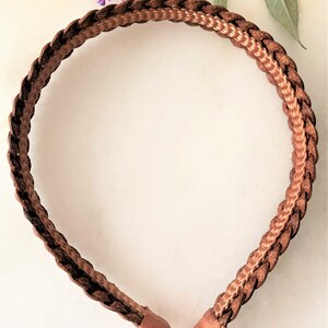 Peut inclure: Un serre-t&ecirc;te tress&eacute; marron avec une bande tiss&eacute;e marron l&eacute;g&egrave;rement plus claire.