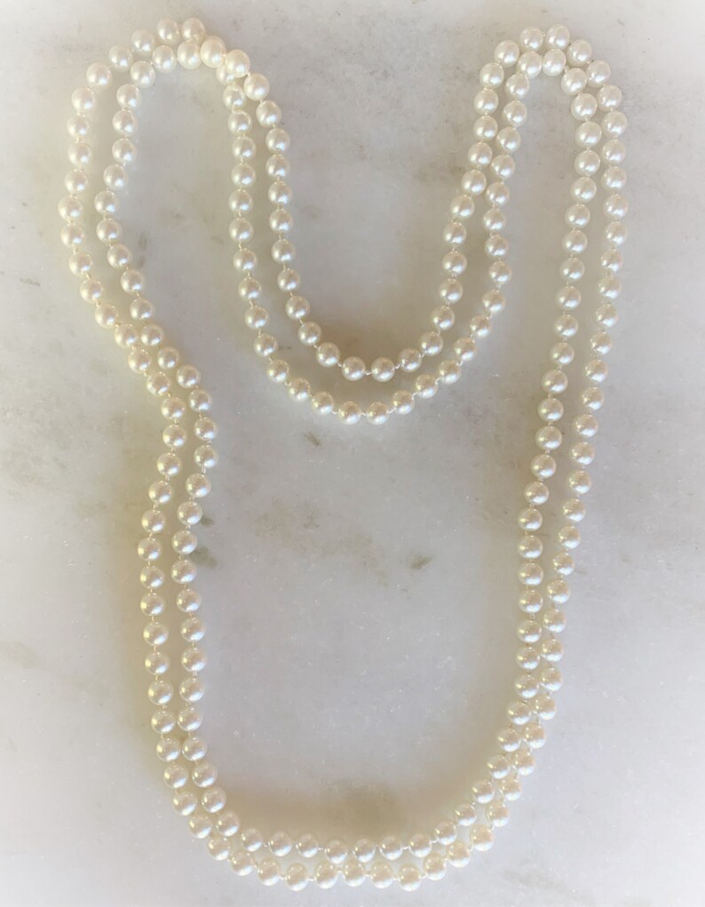 May include: A double strand of white pearl beads necklace.