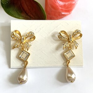Satin Gold Dimensional Bows Set with Crystal Stones and Square Crystal Cabochon Center with Glass Pearl Teardrop Pierced Earrings