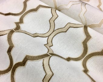May include: White fabric with a geometric pattern embroidered in brown and beige thread.