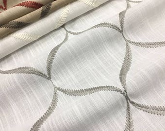 May include: White fabric with a subtle texture and a repeating pattern of gray embroidered curved lines.