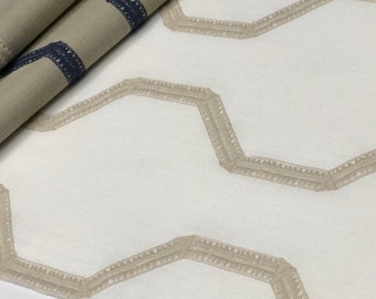 May include: White fabric with a subtle geometric pattern of beige embroidered lines forming a repeating hexagonal shape.