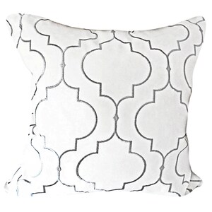 May include: White cushion with a silver geometric pattern.