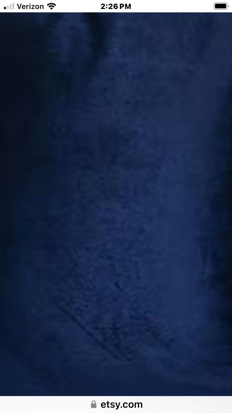 May include: A dark blue fabric with a textured, slightly fuzzy surface. The fabric has a subtle, uneven pattern.