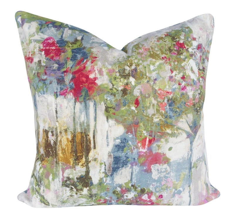 May include: A decorative throw pillow with an abstract floral pattern in shades of blue, green, pink, and white.