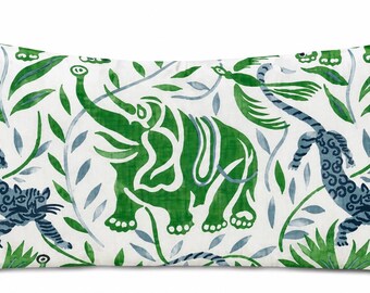 May include: A rectangular throw cushion featuring a white background with a repeating pattern of green elephants and blue-grey tigers. The design includes green leaves and vines interspersed throughout, creating a dense, jungle-inspired botanical motif.