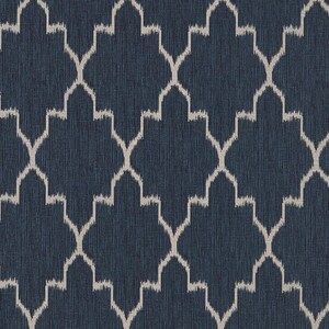 May include: A dark navy blue fabric featuring a repeating geometric pattern of light beige, ikat-style interlocking ogee shapes. The material has a subtle, fine vertical texture throughout, creating a consistent and structured visual appearance.