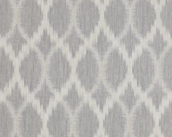 May include: A seamless pattern featuring a repeating ikat design. The pattern showcases a light gray background with a textured appearance, overlaid with a white, diamond-shaped motif. The design is suitable for fabric, wallpaper, or other decorative applications.