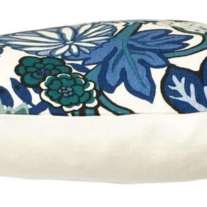 May include: A white pillow with a blue and green floral pattern. The pillow is made of a soft, comfortable fabric and has a white backing.
