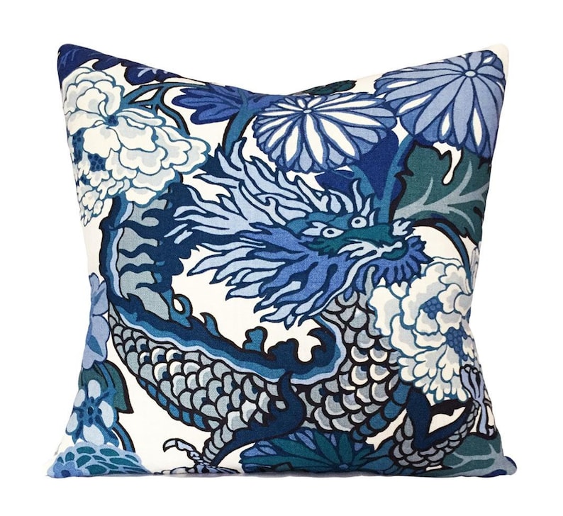 May include: Blue and white pillow with a dragon and floral pattern.
