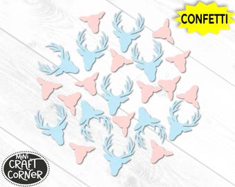 May include: Confetti in the shape of deer heads and antlers in light blue and pink. The word "Confetti" is in a yellow burst. The Mini Craft Corner logo is in the lower left corner. The confetti is scattered on a white wooden surface.