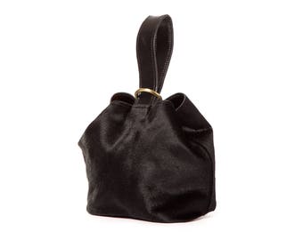 Black Clutch Knot-style wristlet made with cowhide leather
