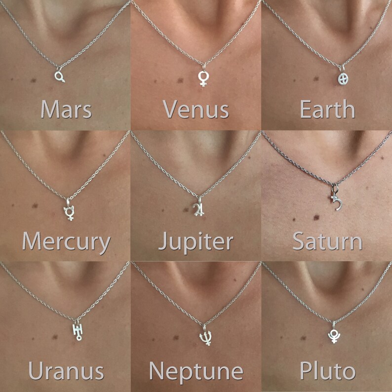 May include: Nine silver necklaces with different planet symbols as pendants. The planets are Mars, Venus, Earth, Mercury, Jupiter, Saturn, Uranus, Neptune, and Pluto.