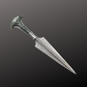 May include: A silver dagger with an ornate, detailed design. The handle is made of dark green jade and features a skull design.