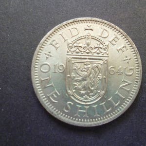United Kingdom 1964 Shilling coin (Scottish Version) ideal gift or for craft or jewellery making in good used (circulated) condition.