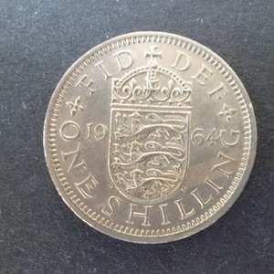 United Kingdom 1964 Shilling coin (English Version) ideal gift or for craft or jewellery making in good used (circulated) condition.