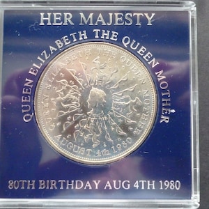 1980 Crown coin, The 80th Birthday of Queen Elizabeth The Queen Mother, in good condition housed in a near scratch free rigid plastic case.