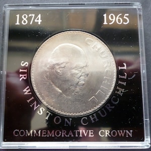 1965 Crown coin, Sir Winston Churchill in good circulated condition housed in a rigid plastic case, features the late Queen Elizabeth Second