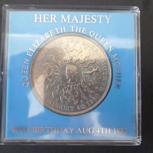 1980 Crown coin, The 80th Birthday of Queen Elizabeth The Queen Mother, in good condition housed in a near scratch free rigid plastic case.