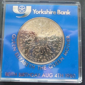 1980 Crown coin, The 80th Birthday of Queen Elizabeth The Queen Mother, in good condition housed in a near scratch free rigid plastic case.