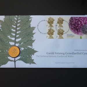 2000 United Kingdom  Coin first Day Cover, The National Botanic  Garden of Wales with a uncirculated one pound coin and four stamps.