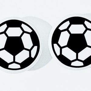 May include: Two white round stickers with black soccer ball designs.