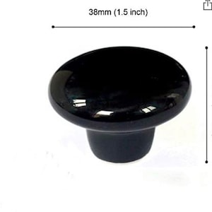 May include: Black ceramic cabinet knob with a rounded top and a smooth, glossy finish. The knob measures 1.5 inches in diameter and 1.1 inches in height.