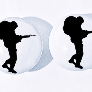 May include: Two white ceramic round buttons with a black silhouette of a soldier carrying a backpack and holding a rifle.