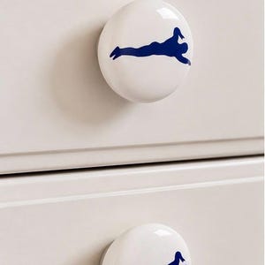 Pair 1.5” Swimmer Drawer Knobs | White Ceramic Pulls with Swimming Decals | Sports-Themed Dresser Hardware
