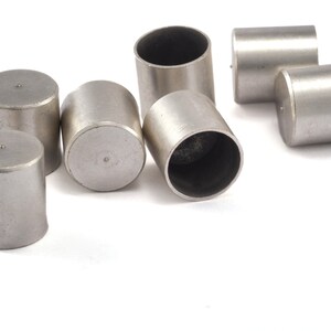 May include: A set of six silver metal cylinder-shaped valve stem caps.