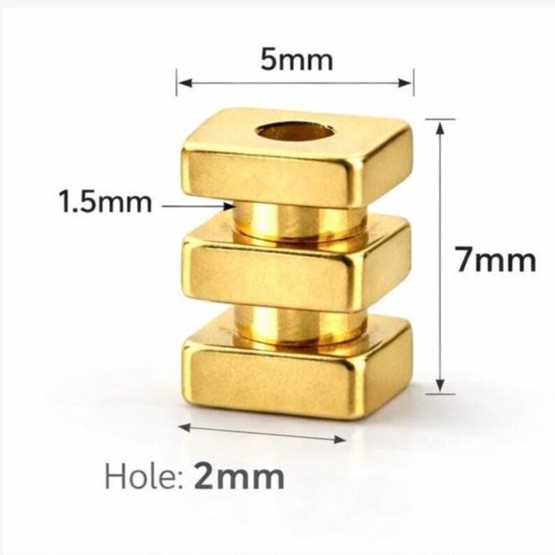 May include: A gold-colored, stacked metal component with a square base and top, and a cylindrical middle section. The component is 7mm tall, 5mm wide, and 1.5mm thick. It has a 2mm hole.