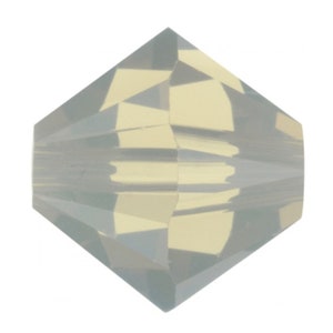 May include: A clear, faceted, iridescent glass bead with a teardrop shape.
