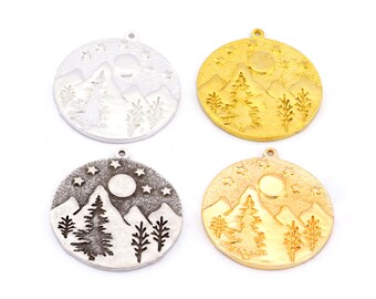 May include: Four round metal charms featuring a mountain, moon, and stars design. Two charms are silver and two are gold.