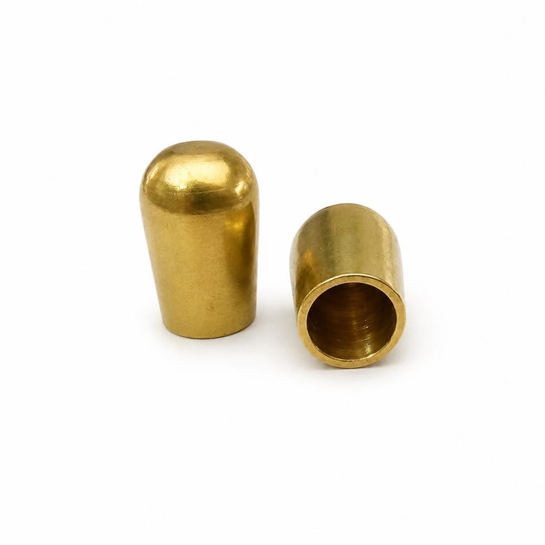 Raw brass cord end cap for 9mm round leather cord with rounded dome shape on white background