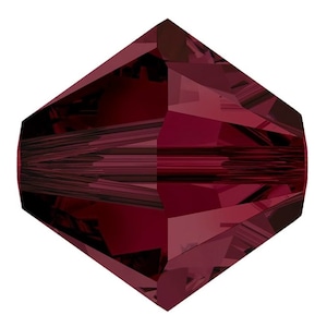 May include: A deep red faceted crystal bead with a pointed tip. The bead is made of glass and has a high shine.