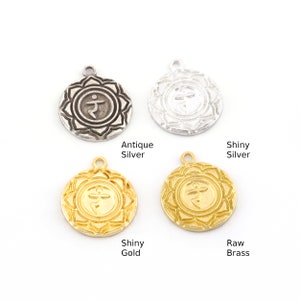 May include: Four round metal charms featuring a symbol and a flower design. The charms are available in antique silver, shiny silver, shiny gold, and raw brass.