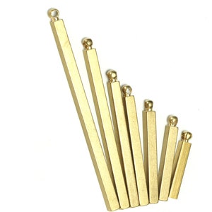 May include: A set of seven gold-colored metal bars with rounded ends. The bars are arranged in descending order of size, with the largest bar at the top and the smallest bar at the bottom.