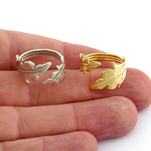 May include: Two adjustable rings with a leaf design. One ring is silver and the other is gold.