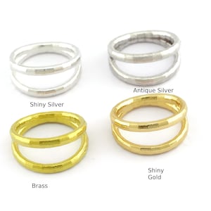 May include: Four double-band rings in different finishes: shiny silver, antique silver, shiny gold, and brass.