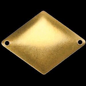 May include: A gold-toned diamond-shaped metal charm with two holes on the sides.