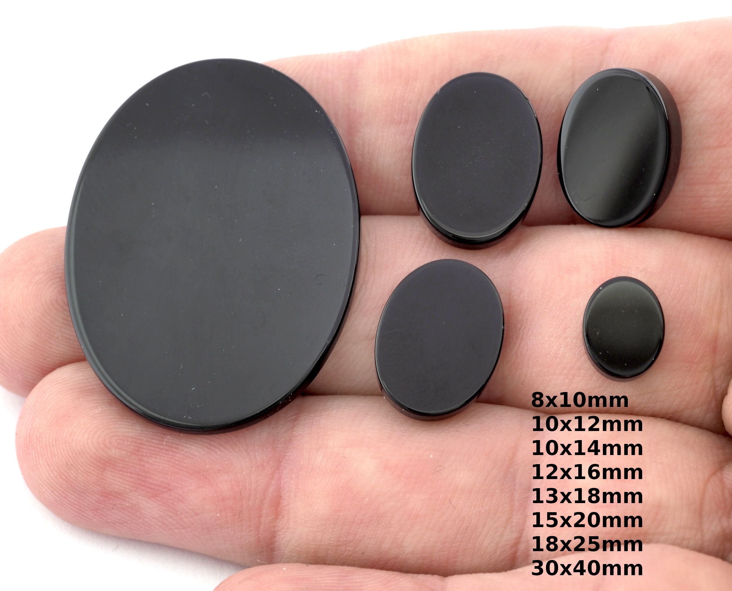 4 sottobicchieri rotondi in pelle nera con supporto | Disponibile