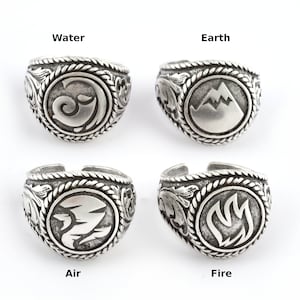 May include: Four silver rings with different designs representing the four elements: water, earth, air, and fire. Each ring features a circular design with a stylized image of the element.