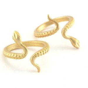 May include: Two gold snake rings with textured details. The rings are open and can be adjusted to fit different finger sizes.