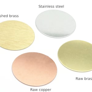 May include: Four round metal discs in different finishes: brushed brass, raw brass, raw copper, and stainless steel.